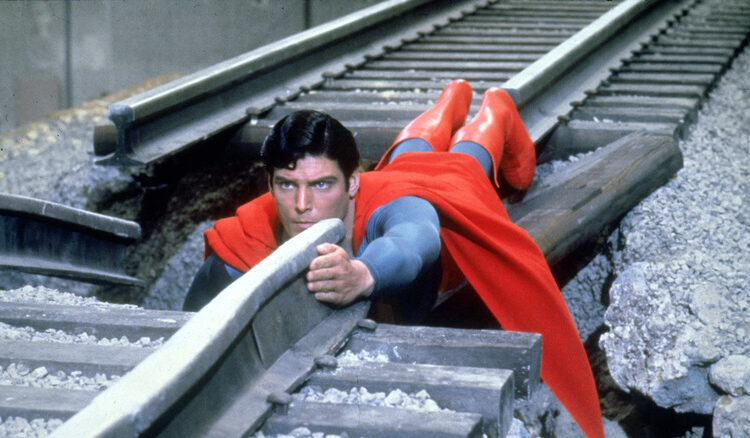 Superman uses his body as a train track