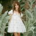 Daisy Edgar-Jones styled a little white babydoll dress from McQueen with the lace-up heels trend