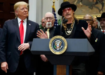 President Donald Trump looks on as musician Kid Rock speaks during a 2018 signing ceremony at the White House.