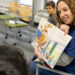 Christie Cole reads book about well-behaved dinosaurs at school.