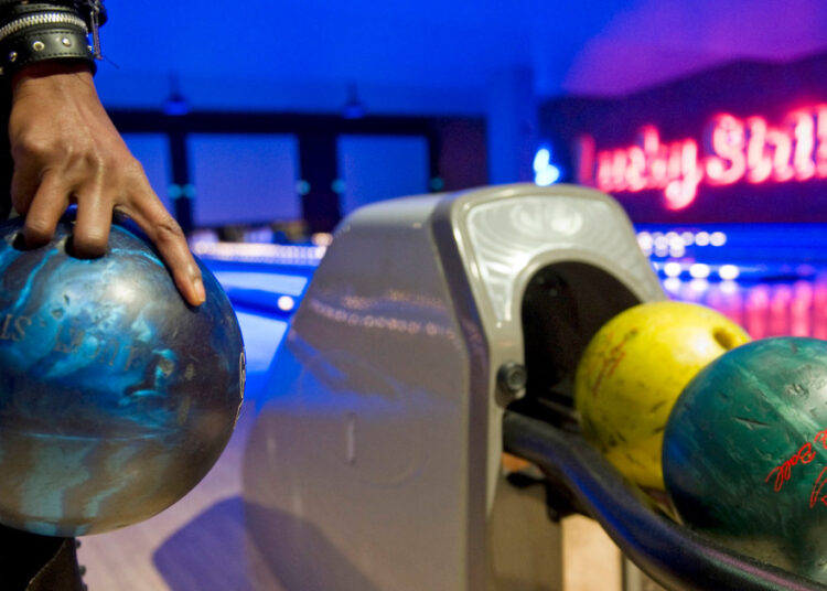 Wall Street goes bowling for profits, driving up the price of a middle-class pastime