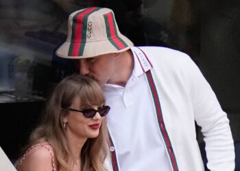 Taylor Swift gets a kiss from Kansas City Chiefs tight end Travis Kelce as they arrive to watch play between Jannik Sinner, of Italy, and Taylor Fritz, of the United States, during the men's singles final of the U.S. Open tennis championships, Sept. 8, 2024, in New York. (AP Photo/Frank Franklin II, File)