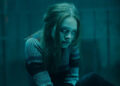 Beatrix glowering in a dark room