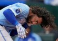Jonathan India, da Kansas City Royals, segura sua mandíbula depois que ele foi atingido por um campo jogado por ...