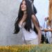 Madison Beer atordoa em um espartilho branco e asas de anjo enquanto ela filma o novo videoclipe em LA