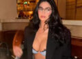 Kylie Jenner não usa nada além de um micro-sutiã como uma blusa com o visual codificado por sirene do escritório