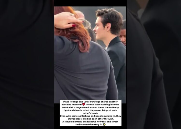 Olivia Rodrigo and Louis Partridge walked through the crowd… and never let go of each other’s hand.