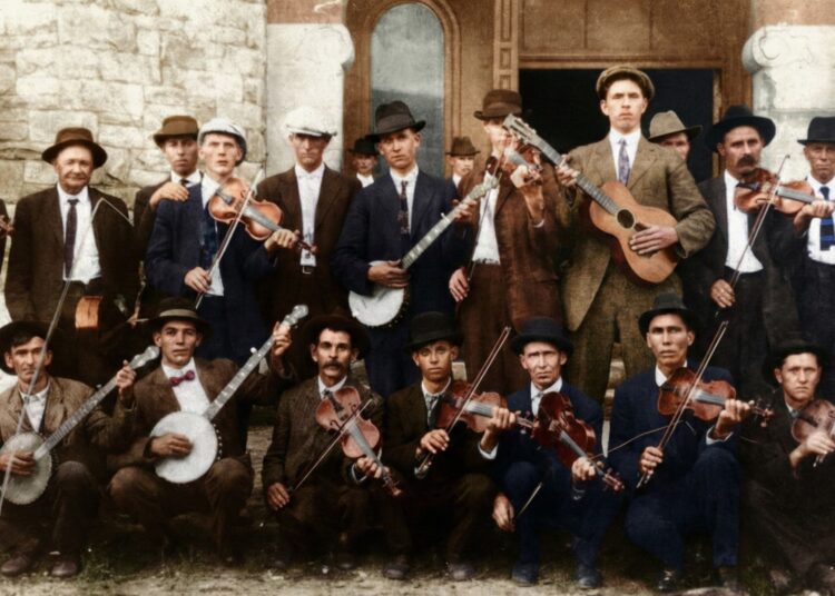Conhecido como “Seven-Foot Dilly”, o homem alto nesta foto colorida com o violão era o bombeiro de Atlanta, John Dilleshaw. As gravações de Dilleshaw estarão acessíveis ao público na Discografia de Gravações Históricas Americanas por meio de uma parceria entre o selo Dust-to-Digital de Atlanta e a Universidade da Califórnia, em Santa Bárbara. (Cortesia de Dust-to-Digital)