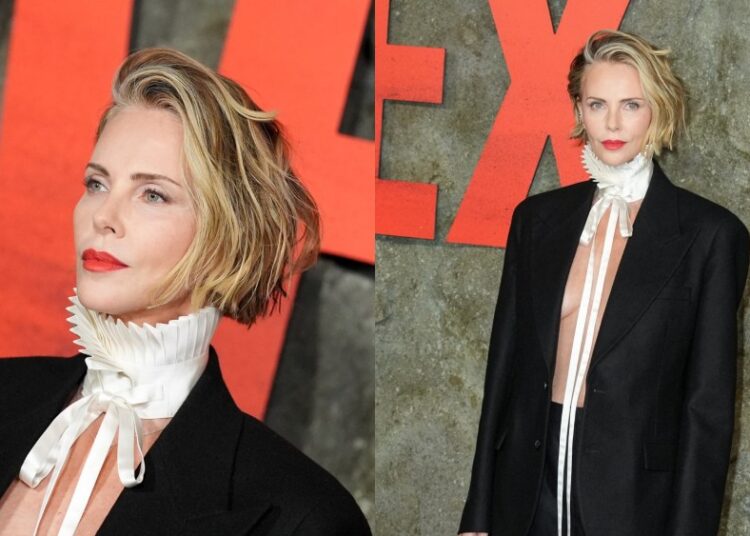 Charlize Theron usa roupa masculina em Christian Dior para estreia de 'Apex'