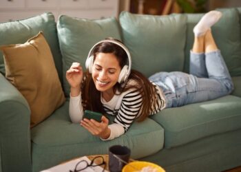 MUJER ESCUCHANDO MÚSICA EN EL SOFÁ