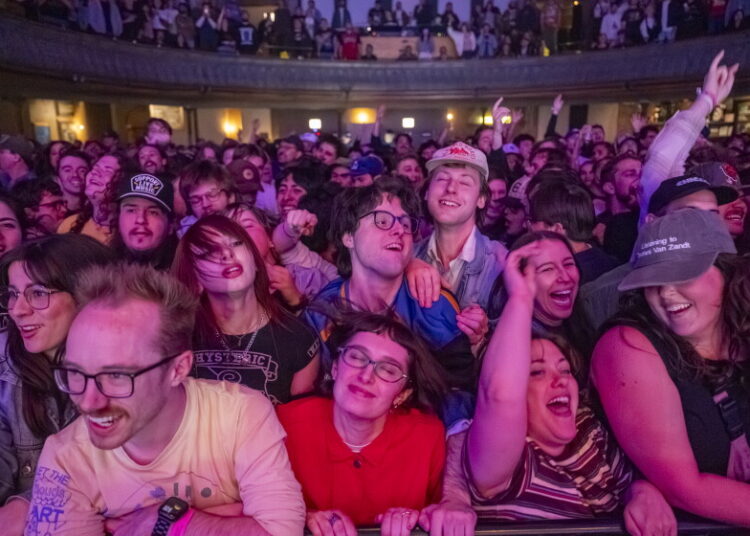 Fans smile in the front row of the Twin Peaks show at Thalia Hall on May 14, 2026