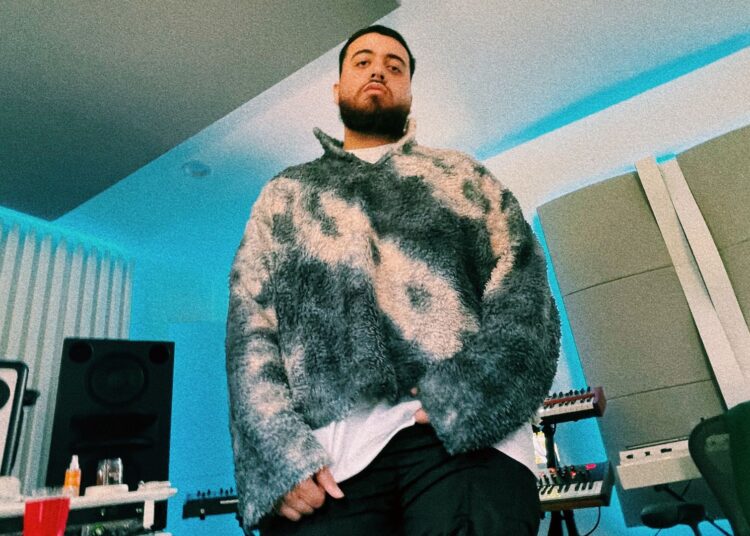 Photo of a man standing in a small studio.