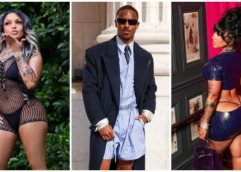 Tres personas con diferentes atuendos: una mujer con cabello largo gris con un traje negro y dorado, un hombre con traje y corbata, y una mujer con un traje azul marino con tatuajes.