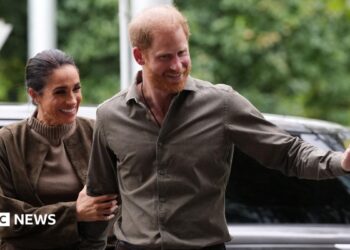The Duke and Duchess of Sussex wave at the crowd after arriving at an event in Melbourne, Australia on 14 April 2026.