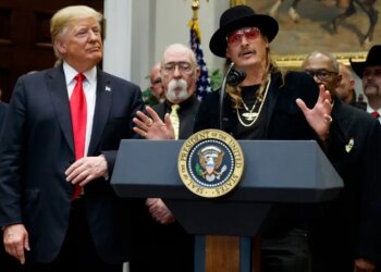 President Donald Trump looks on as musician Kid Rock speaks during a 2018 signing ceremony at the White House.