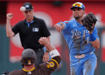 Kansas City Royals second baseman Michael Massey throws to first for the double play hit into by San Diego Padres' Miguel Andujar after forcing Ty France out at second to end the ninth inning of a baseball game Saturday, July 18, 2026, in Kansas City, Mo. (AP Photo/Charlie Riedel)
