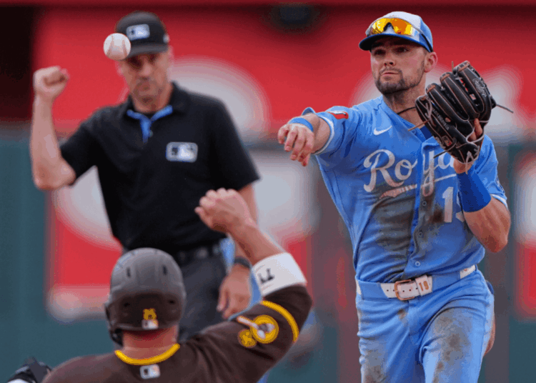 Kansas City Royals second baseman Michael Massey throws to first for the double play hit into by San Diego Padres' Miguel Andujar after forcing Ty France out at second to end the ninth inning of a baseball game Saturday, July 18, 2026, in Kansas City, Mo. (AP Photo/Charlie Riedel)
